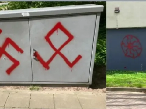 Gebouwen, bushaltes en monumenten beklad met hakenkruizen